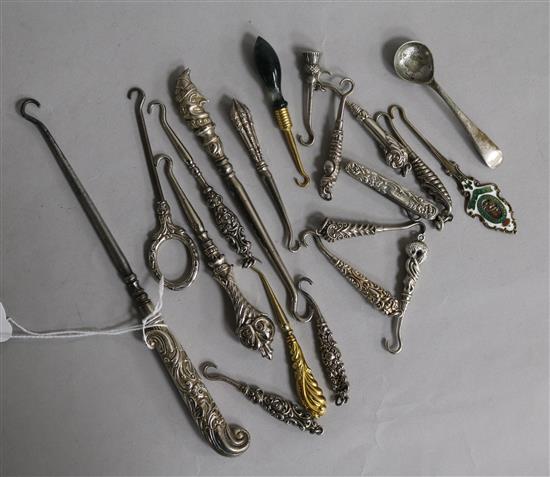 A collection of silver handled button hooks, a gold handled button hook and other items.